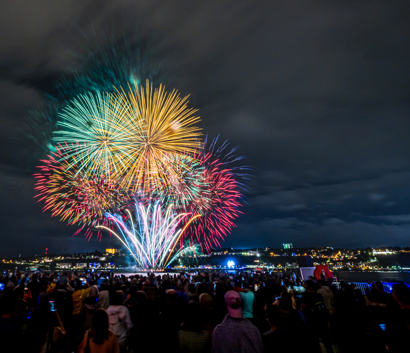 Fireworks launched from a barge in the middle of the St. Lawrence River