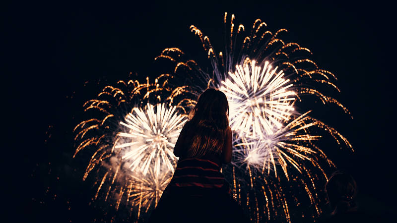 Little girl from de back looking at fireworks